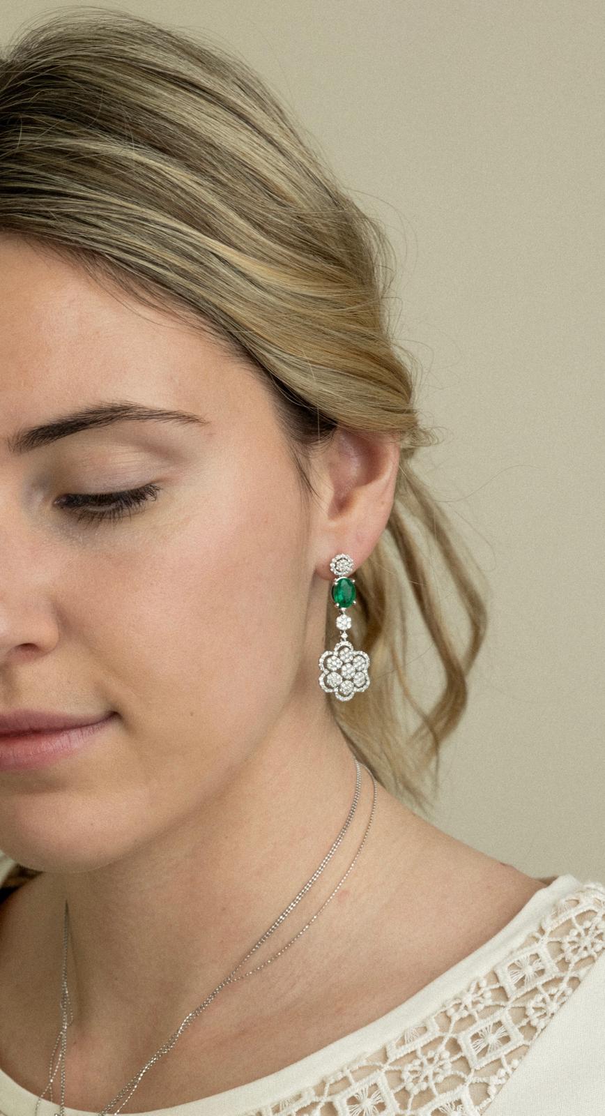 Green gemstone and diamond floral drop earring side portrait