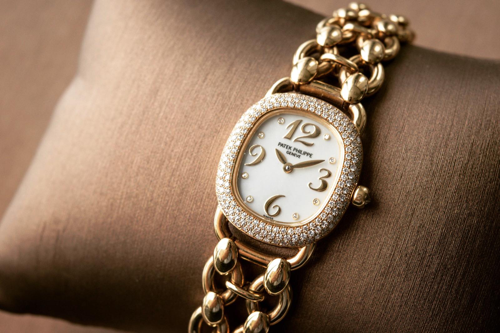 Ladies Patek Philippe watch with diamond-set bezel and gold bracelet