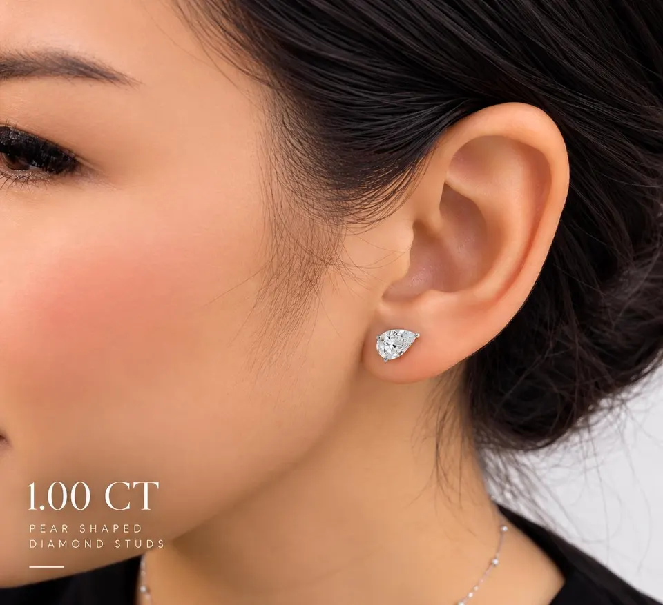 Pear diamond stud worn — 1.00 ct size reference supplied by the atelier