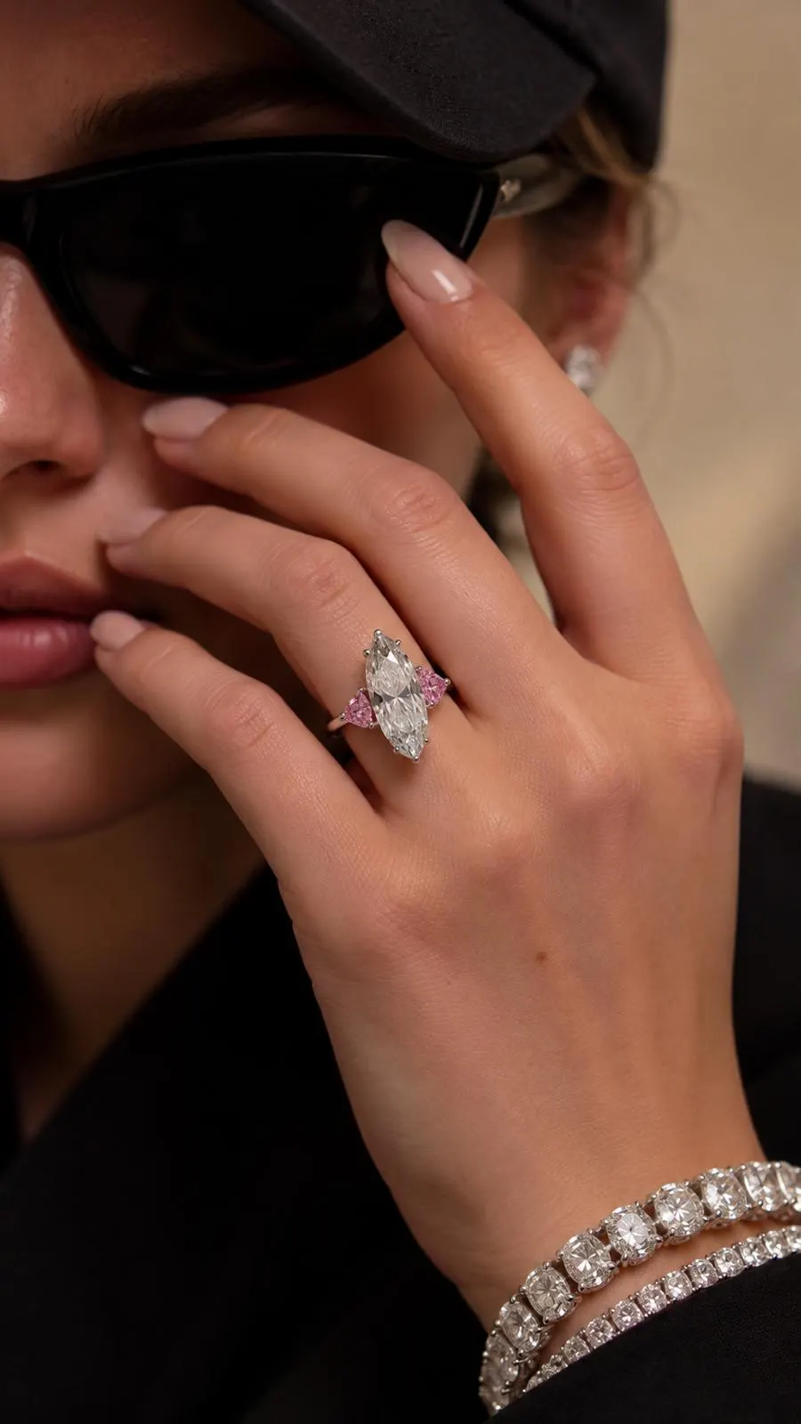Moval diamond and pink sapphire ring worn on the hand
