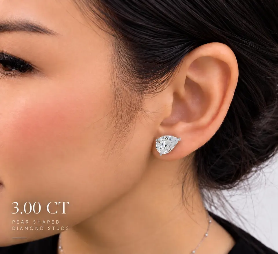 Pear diamond stud worn — 3.00 ct size reference supplied by the atelier