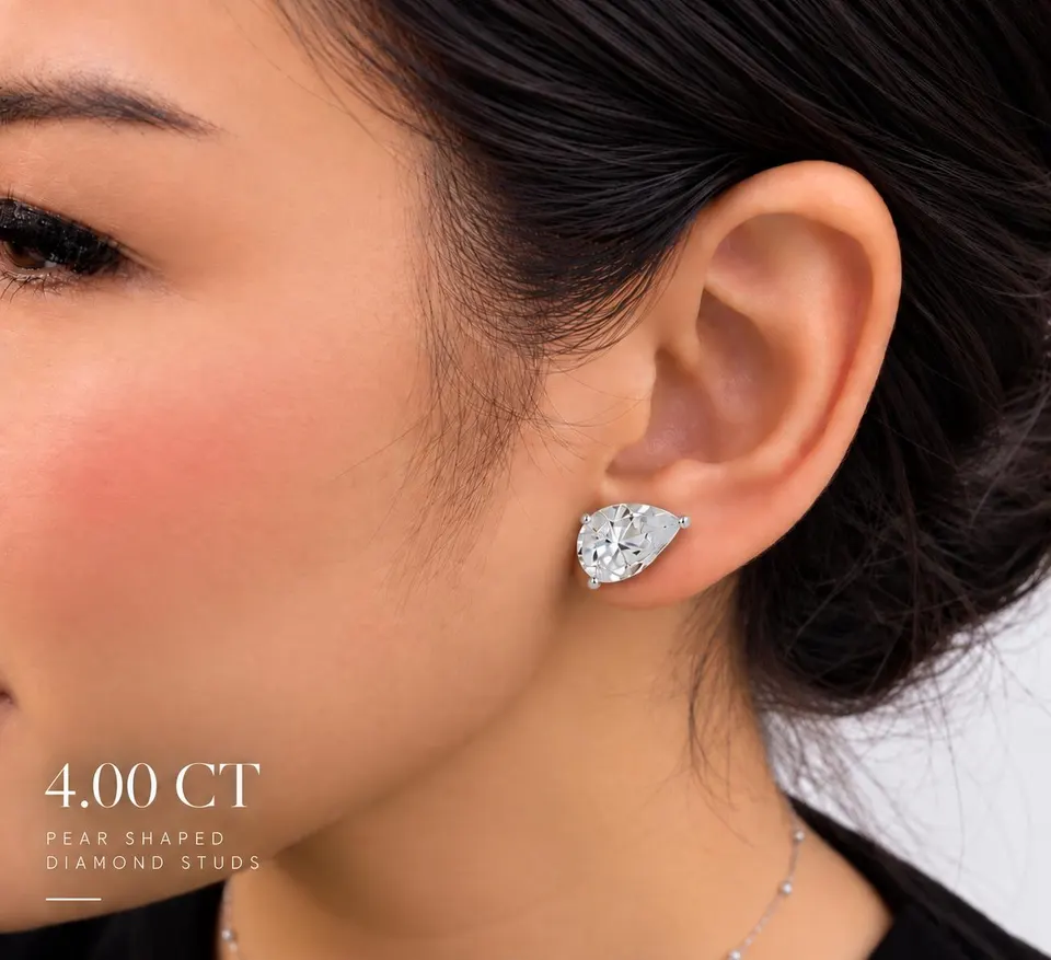 Pear diamond stud worn — 4.00 ct size reference supplied by the atelier