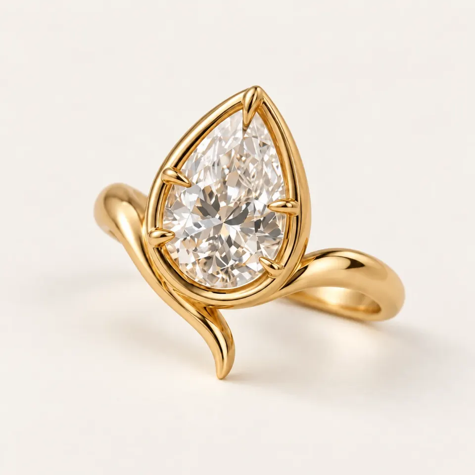 Pear lab diamond in a sculptural yellow gold bezel-inspired setting with a sweeping curved flourish